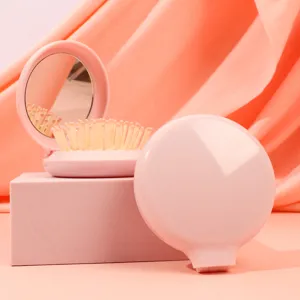 Portable pink folding hairbrush with mirror, compact round airbag massage comb for travel.