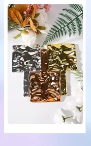 Detail view of electroplated handheld mirrors with ripple texture in metallic finishes