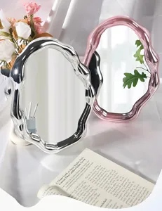 Modern cloud-shaped irregular wavy makeup mirrors with silver and pink electroplated frames.