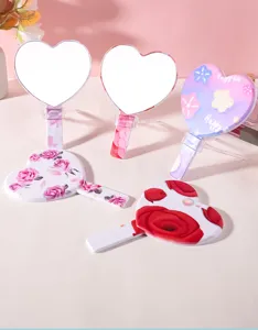 Detail view of portable heart-shaped handheld mirrors with various floral patterns