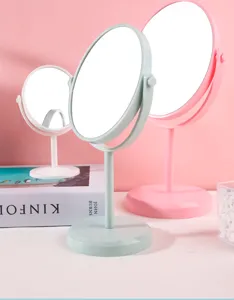 Rotatable desktop makeup mirrors in three pastel colors on a pink background