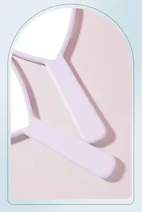 Detail view of smooth plastic handles on pastel purple heart-shaped hand mirrors