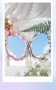 Two cloud-shaped irregular makeup mirrors with electroplated pink and silver frames reflecting blue sky.