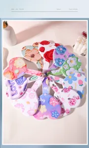 Top-down view of multiple heart-shaped handheld mirrors with diverse floral designs