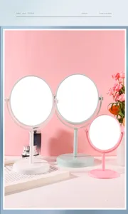 Detail shot of three rotatable desktop makeup mirrors in white, pink, and mint green.