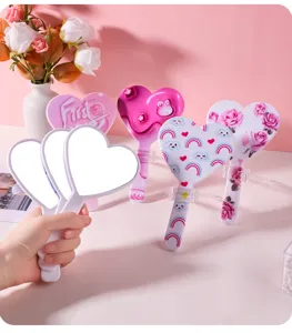 Detailed view of cute heart-shaped handheld mirrors in various floral and rainbow patterns
