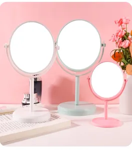 Detailed view of rotating desktop makeup mirrors in pink, white, and mint green