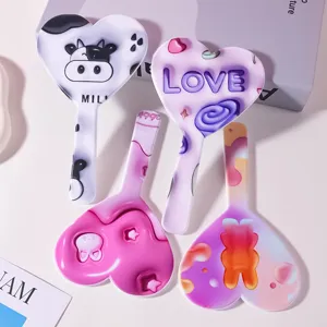 Small heart-shaped handheld mirror with cute cartoon patterns and handles for makeup
