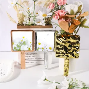 Square electroplated handheld makeup mirrors in rose gold, silver, and gold hammered finish