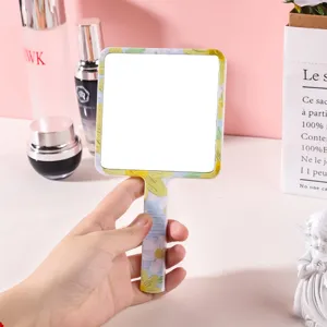 Miroir à main avec un motif floral, verre carré et poignée ergonomique