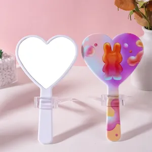 Cute heart-shaped handheld makeup mirror with portable handle and colorful bunny design