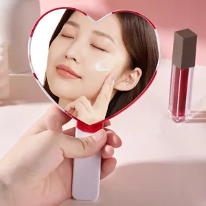 Portable heart-shaped handheld makeup mirror with soft ergonomic handle for daily use