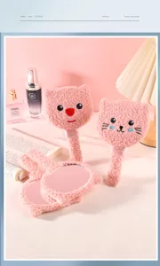 Close-up of pink plush cartoon handheld mirrors with soft fleece texture