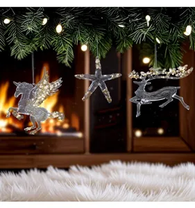 Detailed view of three acrylic Christmas ornaments: a unicorn, a starfish, and a reindeer.