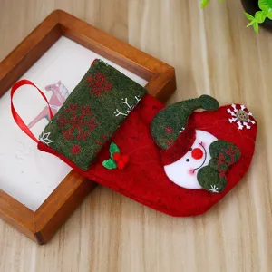 Red and green felt Christmas stocking gift bag featuring a snowman and snowflake patterns