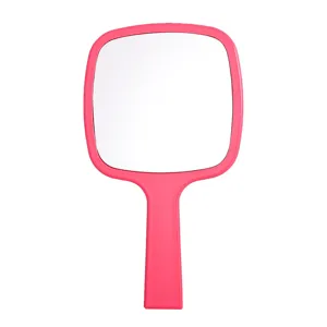 Pink handheld makeup mirror with a portable plastic handle for professional beauty use