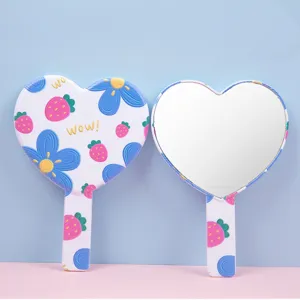 Sweet heart-shaped handheld makeup mirror featuring pink strawberry and blue flower patterns