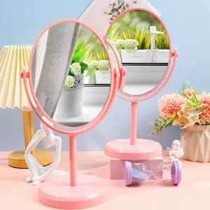 Pastel pink revolving desktop vanity mirror with oval glass for bedroom and dorm decor