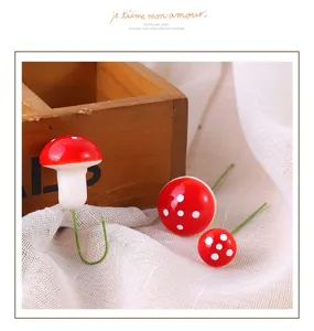 Detailed view of miniature red foam mushrooms with white spots for fairy garden decor