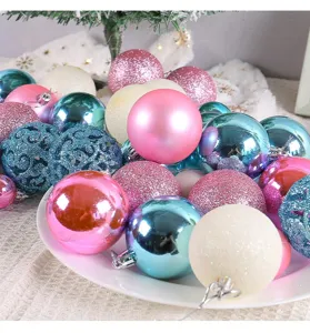Detail view of colorful pink, blue and white Christmas ornament balls in a white plate