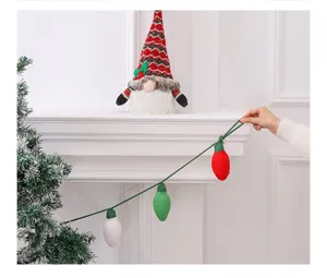 Detail view of knitted colorful bulb Christmas hanging ornaments on a white mantle.