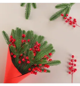 Detail view of artificial Christmas pine needles and vibrant red berries decorative bundle