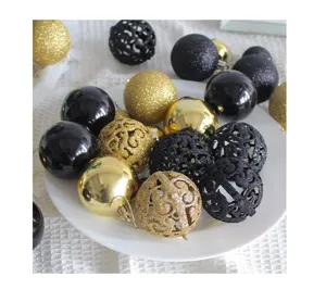 Close-up of elegant gold and black Christmas balls with various textures and patterns