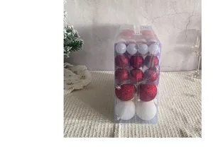 Detail of red and white Christmas ball ornament set in transparent gift box packaging