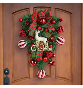 Detailed macro view of Christmas teardrop wreath with white reindeer and glittery greeting sign