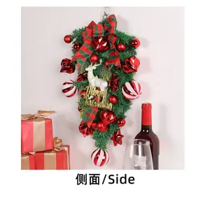 Detailed side view of a Christmas teardrop swag with reindeer and red ornaments