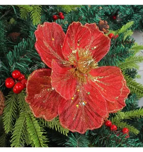 Detailed close-up of a red mesh Christmas flower ornament with sparkling gold glitter