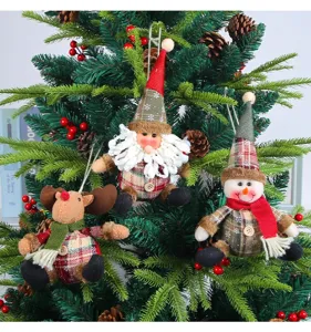 Detailed view of plaid Christmas plush ornaments hanging on a festive evergreen tree