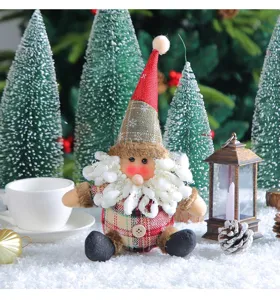 Detail view of a plush Christmas Santa doll with a checkered outfit and red snowflake hat.