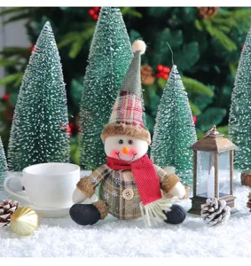 Detail shot of a cute checkered plush snowman with a red scarf for Christmas decor.