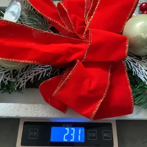 Detailed close-up view showing the weight of the Christmas red velvet bow wreath is 231g