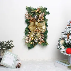 Detailed close-up view of a golden glitter bow on a green Christmas staircase swag