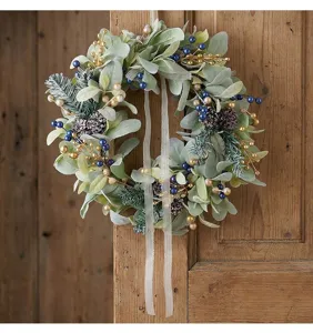 Detailed view of artificial Christmas wreath with lamb's ear leaves and blue berries