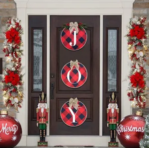 Festive Christmas front door decoration with JOY buffalo plaid signs and lit garlands