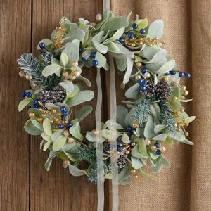 Elegant Christmas wreath featuring frosted lamb's ear leaves and blue berries on wood