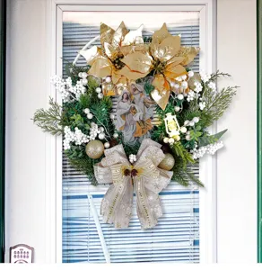 Detailed shot of a golden Christmas wreath with holy family icon and glowing lantern