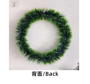 The back view of a green and black tinsel Christmas wreath used for holiday home decoration.