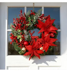 Close-up of Christmas wreath with red poinsettias and reindeer hanging on a door