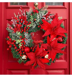 Detailed view of a lush Christmas wreath with red flowers and a glittery reindeer