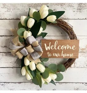 Detailed view of farmhouse tulip wreath with Welcome to our home wooden sign decoration