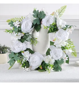 Detailed view of an elegant artificial white peony wreath used for festive door decoration