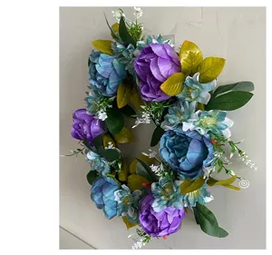 Side view of an artificial peony flower wreath hanging on a neutral wall for home decor.