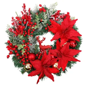Christmas wreath with pine needles red poinsettias berries and glittery deer ornament