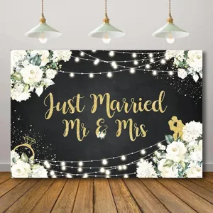Elegant floral wedding backdrop with Just Married Mr & Mrs gold glitter lettering