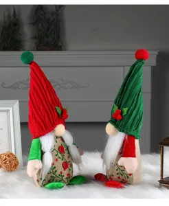 Pair of cute Christmas faceless gnomes with red and green hats and cherry accents