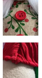 Detailed macro view of red knit fabric and burlap texture on a cute Christmas gnome